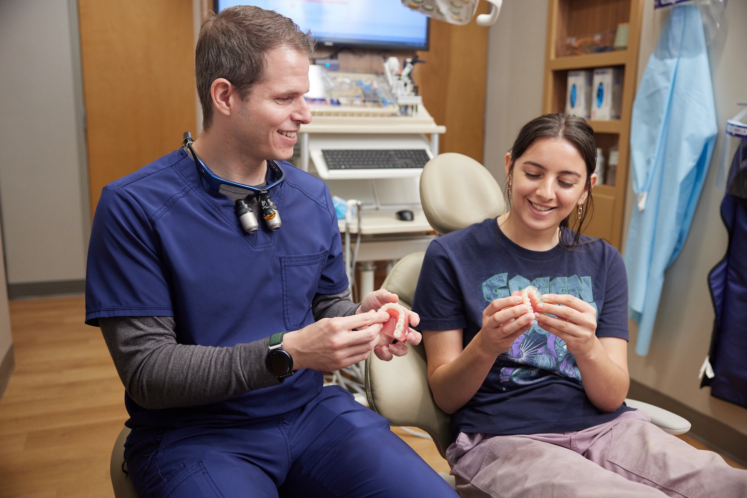 dentist explaining Perio Protect to a patient