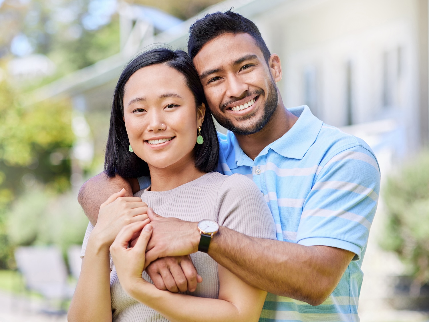 couple smiling with arms around each other