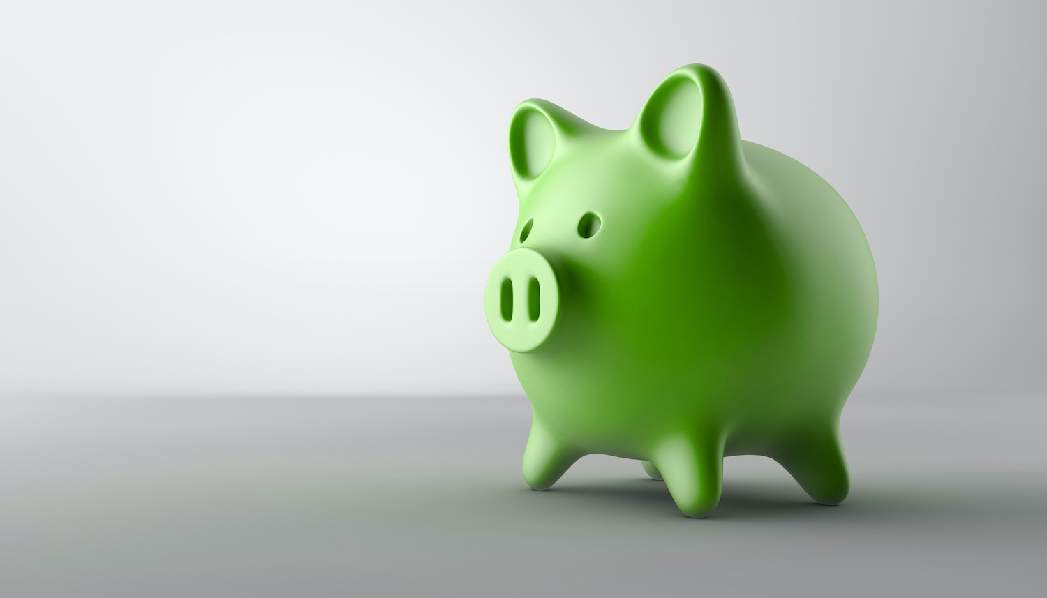 A green piggy bank on a grayscale background to indicate savings with Delta Dental insurance